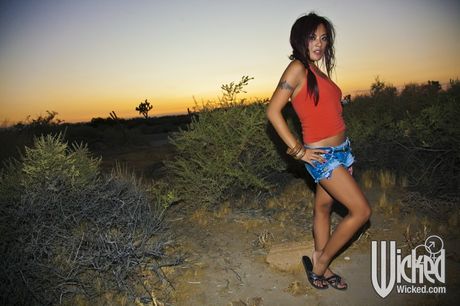 Curious asian milf Kaylani Lei exhibits her butt in skirt and spreading her legs outdoor